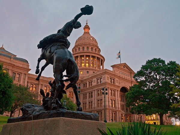 Cowboy Memorial in front of Texas Capitol dome